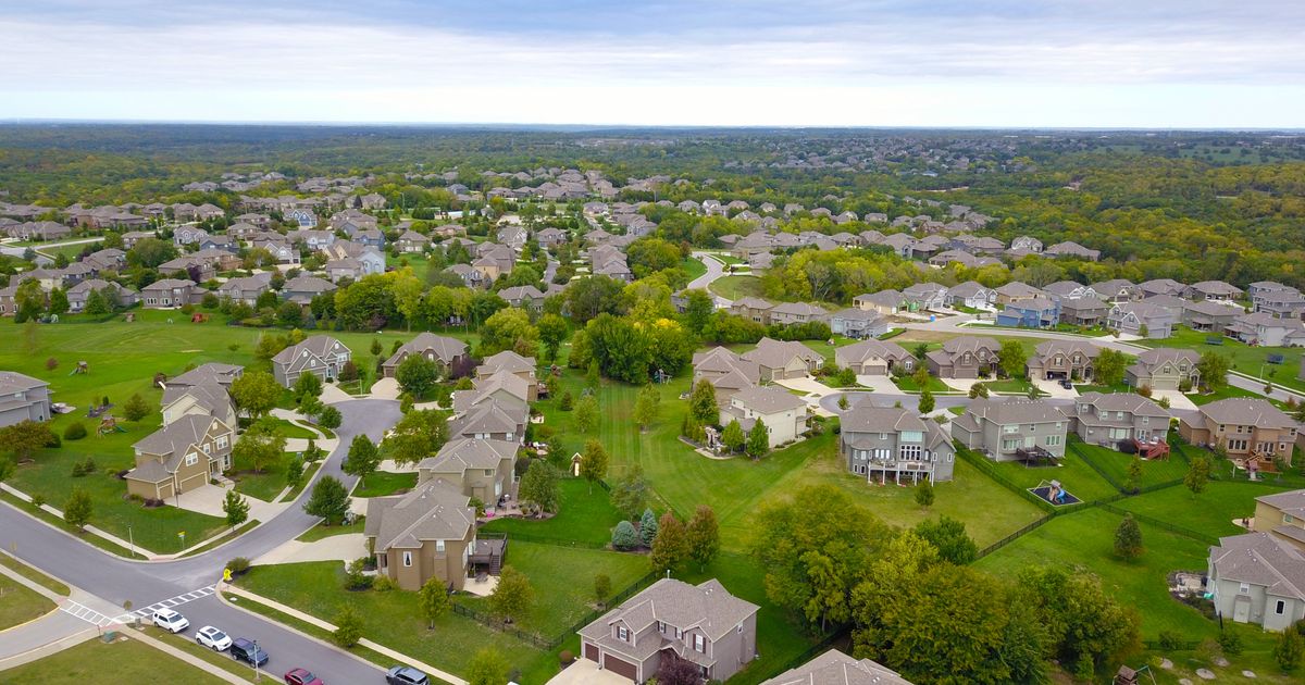 Aerial view of thousands of suburban houses stretching to the horizon