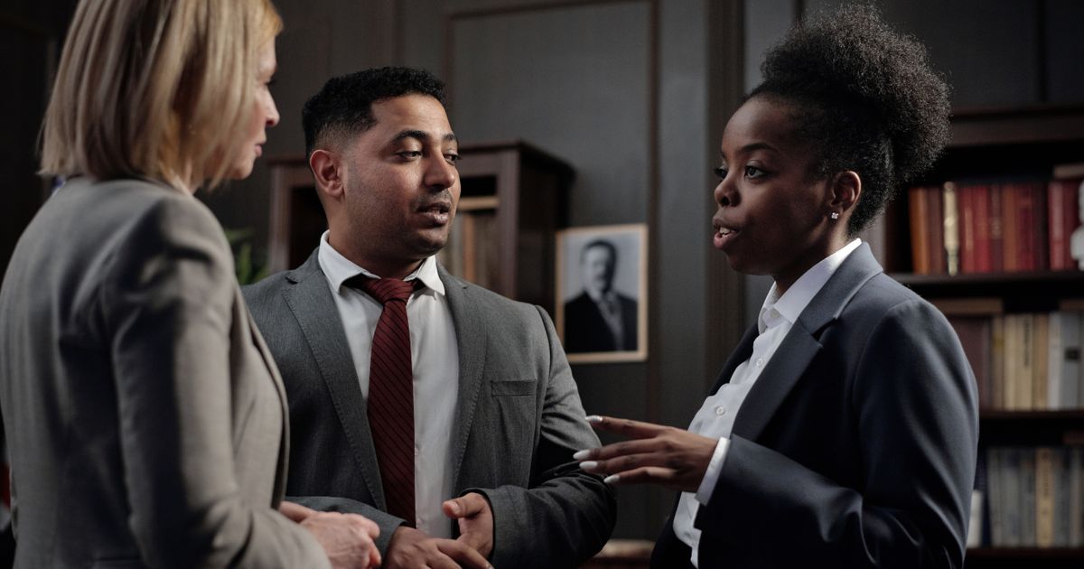 A commercial insurance broker meeting business clients in an office